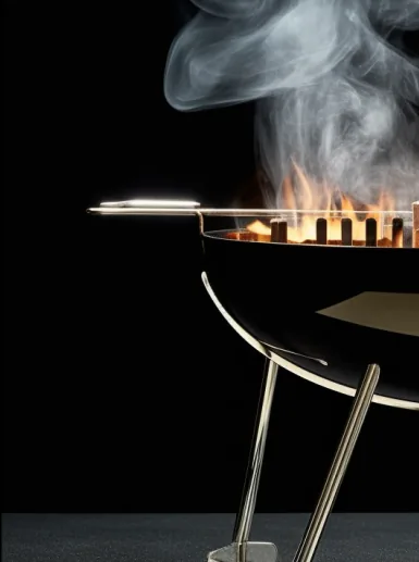 Flames and smoke rising from a wood-fired grill
